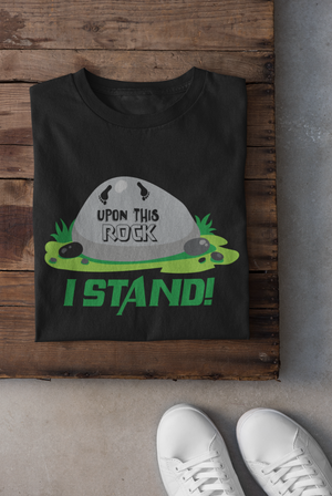 Black t-shirt with logo that reads "upon this rock I stand" in green, black, and grey letters. 