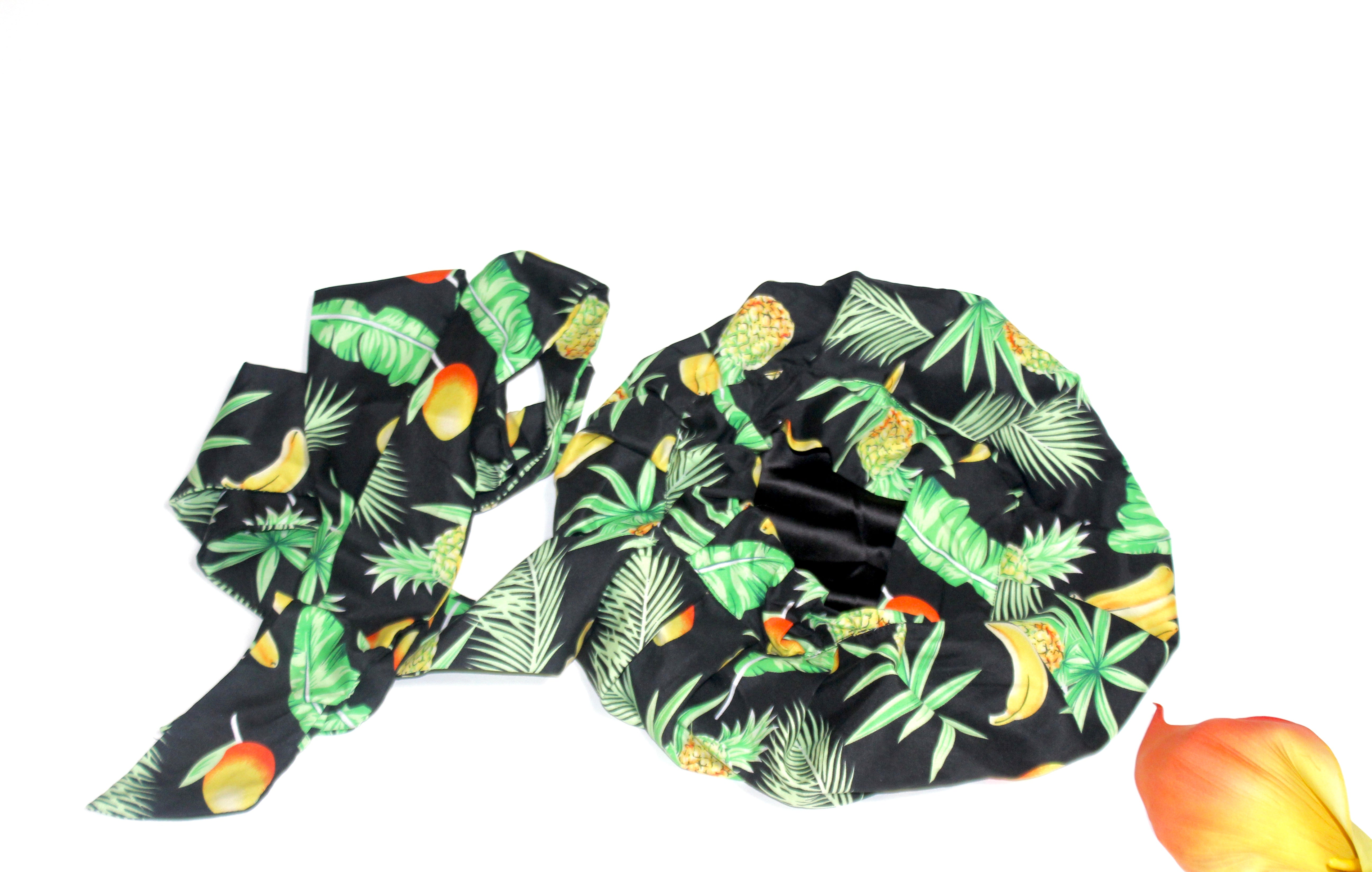 Satin-lined natural hair bonnet with tropical floral pattern on a white background.